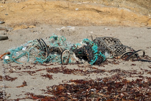 Discarded abandoned fishing gear on a beach in Cornwall England, a danger to wildlife.