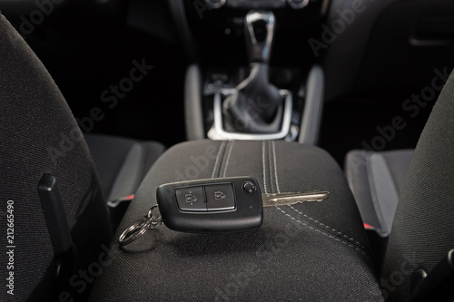 Obraz na plátne key lies inside the car's interior on the armrest
