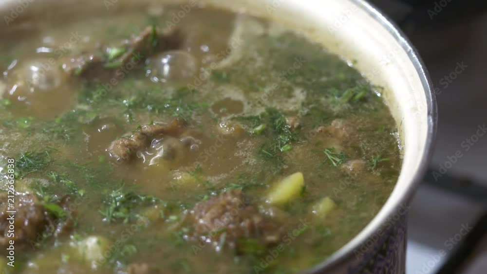 Сooking meat stew with potato. Pork stewed with potatoes and spices in pot closeup. Dish of Russian cuisine Zharkoe. Сooking meat stew with potato. Pork stewed with potatoes and spices in pot closeup. Dish of Russian cuisine Zharkoe.