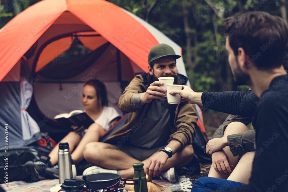 Friends camping in the forest together - obrazy, fototapety, plakaty 
