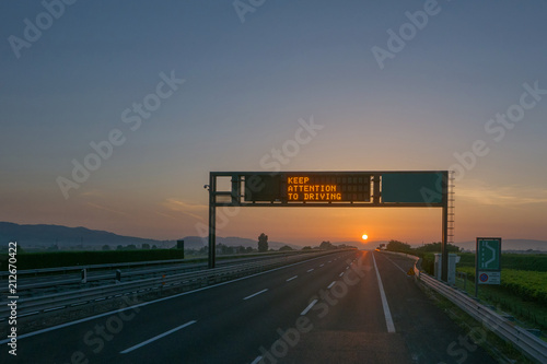 Keep attention to driving written on highway road sign