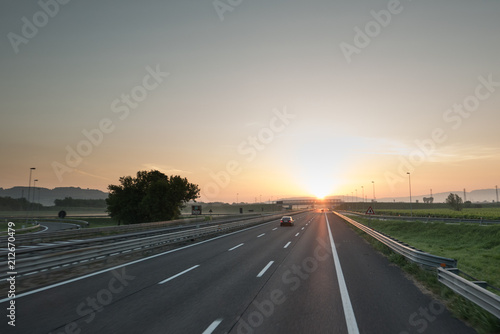 Highway travel background, motorway towards sun
