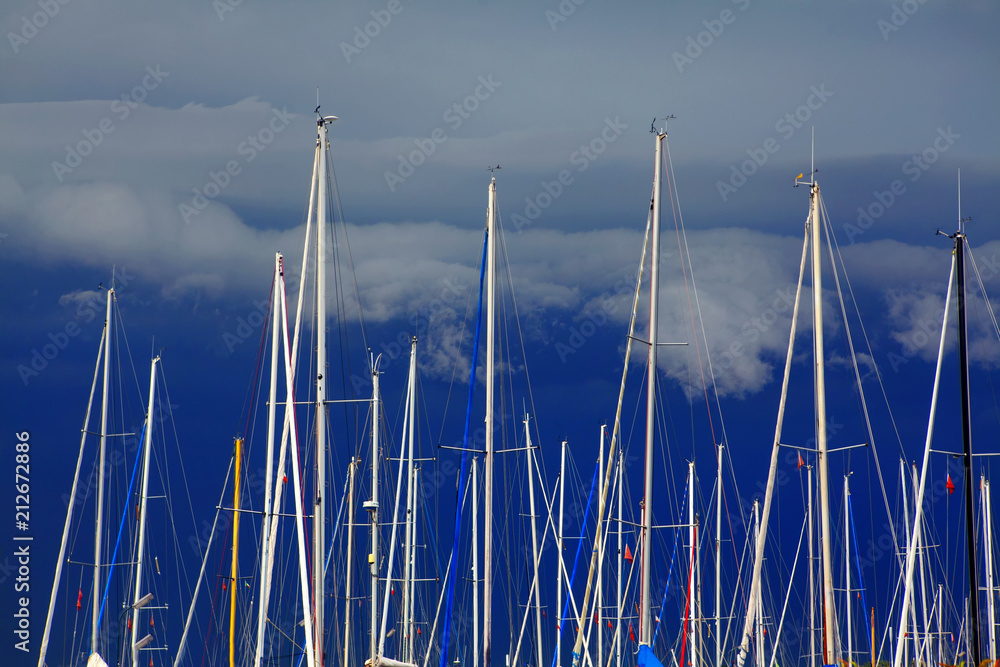 Harbor With yachts ,masts against dark blue sky Harbor With yachts ,masts against dark blue sky