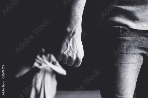 Scared woman protecting from mans aggression. Domestic violence concept