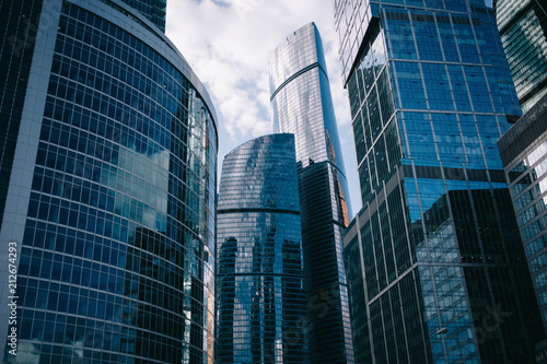 Moscow, Russia - 07 09 2018: Bottom view of Moscow-City skyscrapers with futuristic design with reflection of clouds