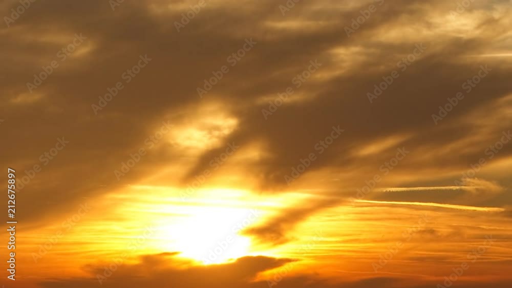 Sunset time lapse in impressive fire and smoke colours. Close up focusing on sky close to the setting sun only. Sunset time lapse in impressive fire and smoke colours. Close up focusing on sky close to the setting sun only.