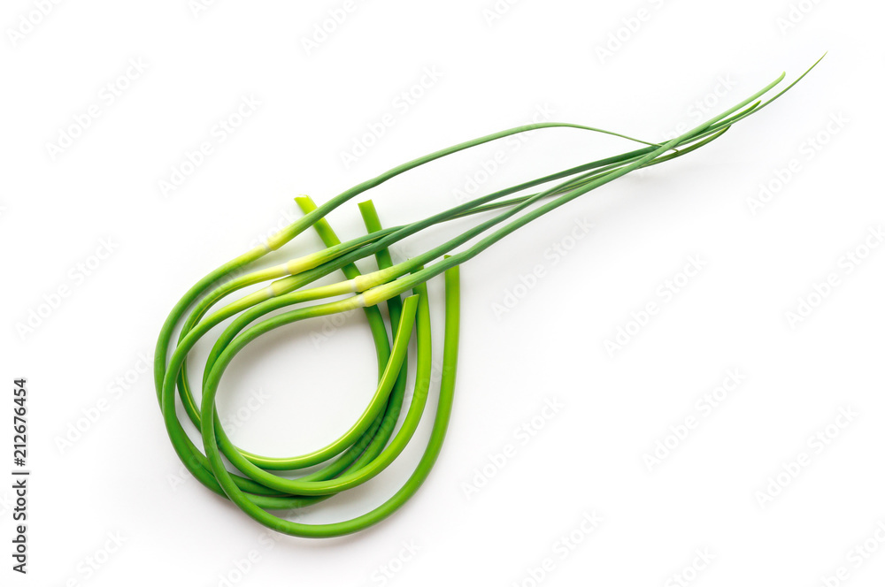 Isolated garlic scapes. Curved chives. Healthy green vegan food. Top view. Isolated garlic scapes. Curved chives. Healthy green vegan food. Top view.