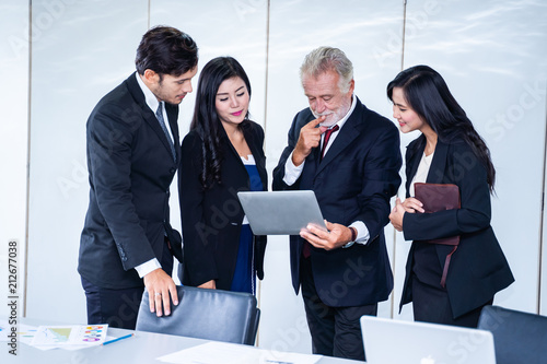 group of successful businessman. Discussion of the business profits of the company in meeting roon or conference room.