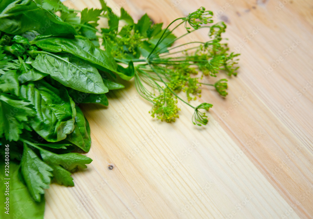 Basil and salad and dill next to a wooden background Basil and salad and dill next to a wooden background