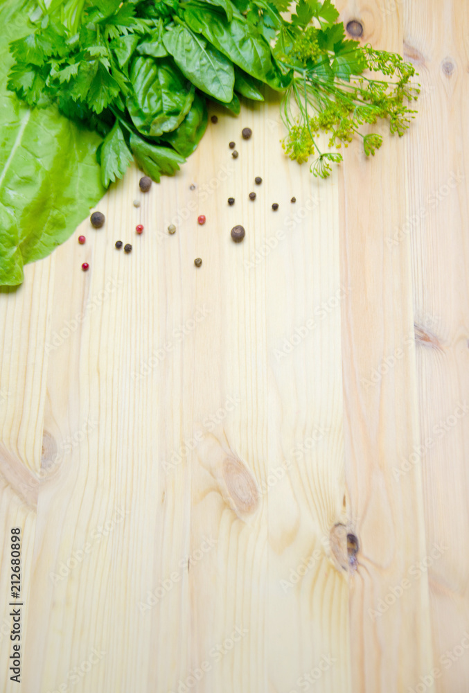 Basil and salad and dill next to pepper peas on wooden background Basil and salad and dill next to pepper peas on wooden background