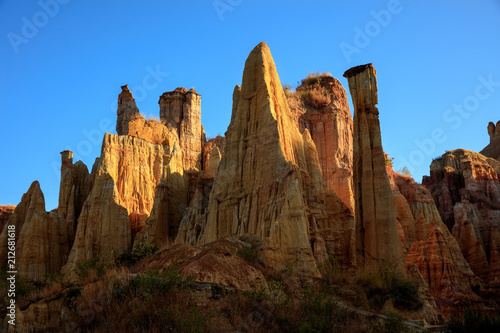 Earth Forest of Yuanmou in Yunnan Province  China - Exotic earth and sandstone formations glowing in the sunlight. Naturally formed pillars of rock and clay with unique erosion patterns. China Travel