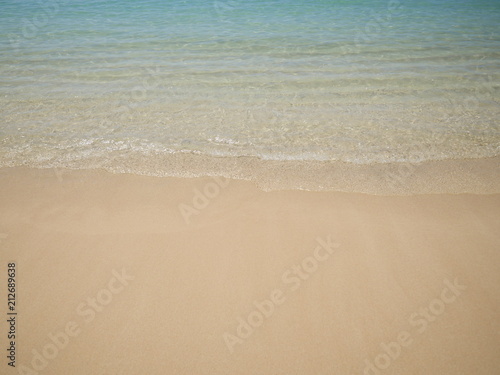 beach shore clear ocean water and white sand background  © Anastasia