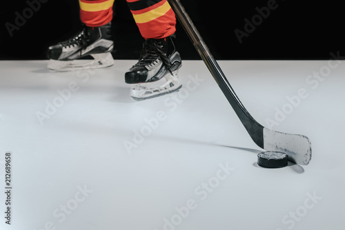 Photography partial view of professional sportsman playing hockey on black