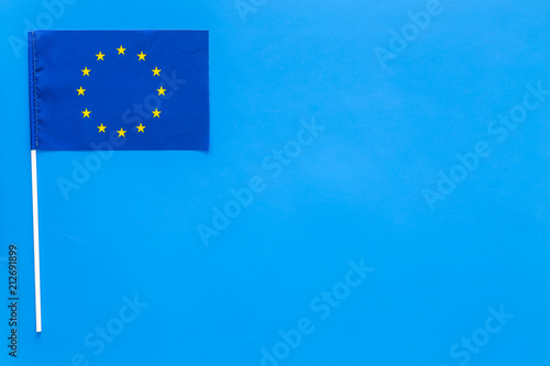 Flag of Europe concept. small flag on blue background top view copy space