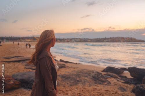 Blonde surfer girl relaxing by australian beach