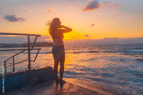 Blonde surfer girl relaxing by the beach