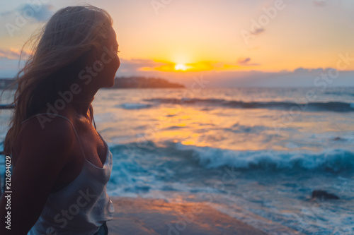 Blonde surfer girl relaxing by the beach