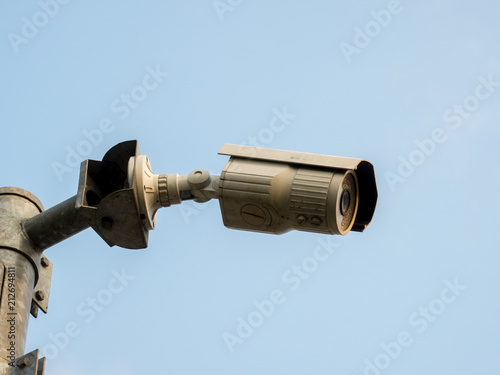 CCTV, Security Camera In The City On Blue Sky Background.