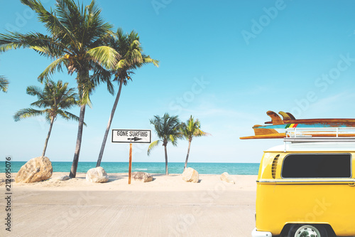 Vintage car with surfboard on roof on tropical beach in summer. beach sign for gone surfing. Vintage effect color filter.