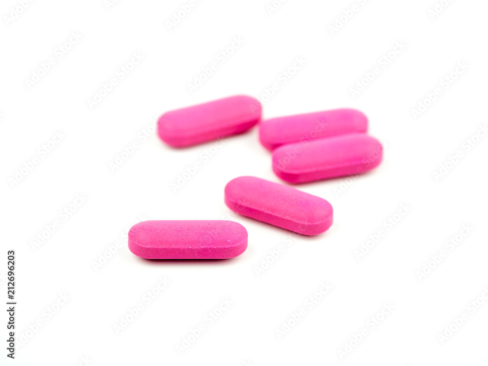 The pink pill is placed on a white background. The pink pill is placed on a white background.