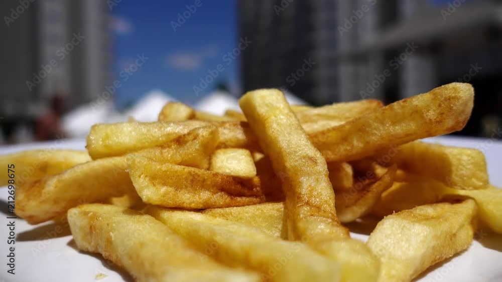 Fried French potatoes are delivered by the waiter. Fried French potatoes are delivered by the waiter.