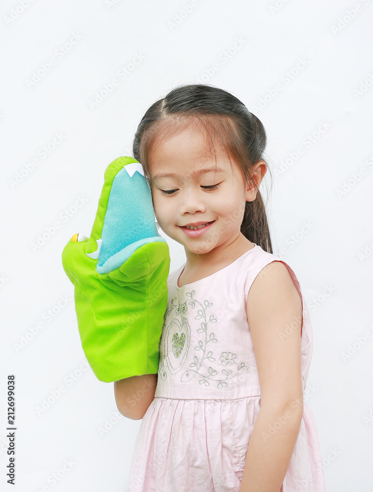 Adorable little Asian child girl hand wear and playing Crocodile puppets on white background. Adorable little Asian child girl hand wear and playing Crocodile puppets on white background.
