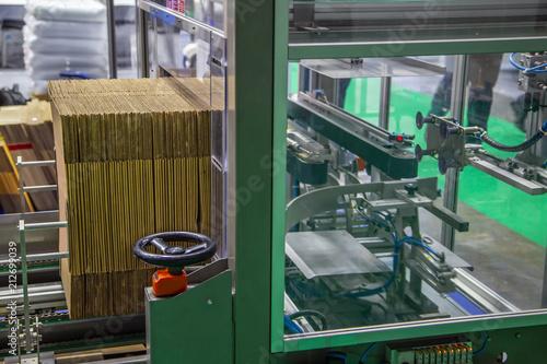 Automatic carton erector machine. Industrial warehouse machinery photo