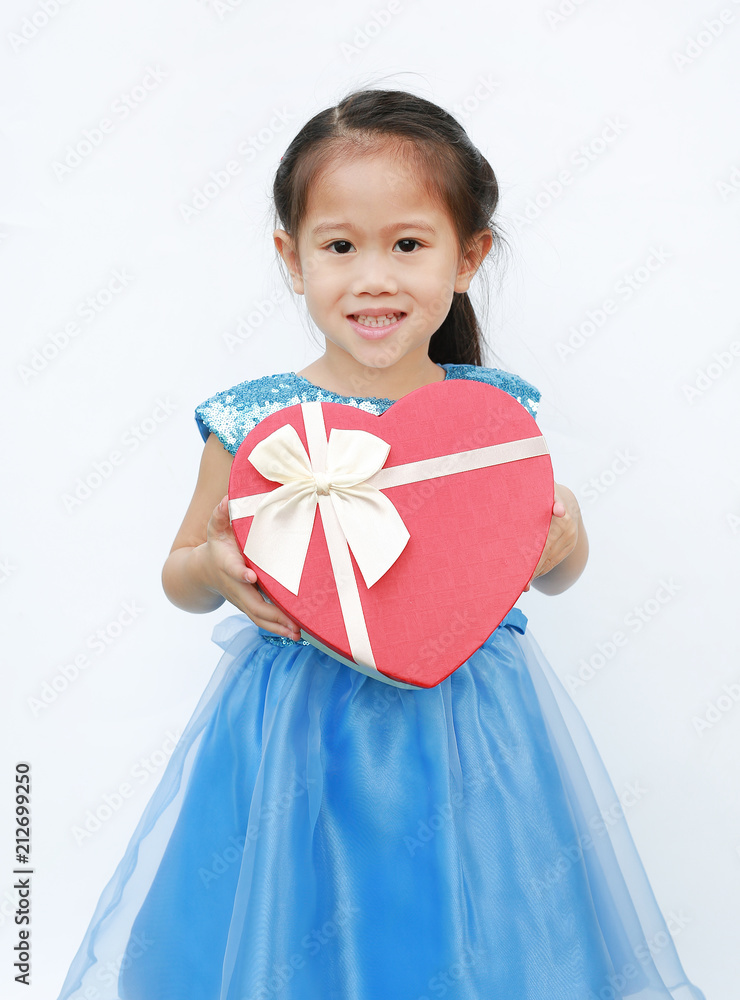 Smiling little child girl receiving red heart gift box isolated on white background.
Smiling little child girl receiving red heart gift box isolated on white background.