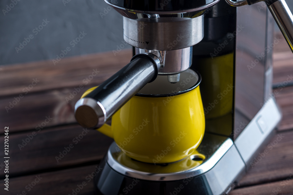 Preparation of espresso. Black coffee machine on the table. Professional coffee brewing Preparation of espresso. Black coffee machine on the table. Professional coffee brewing