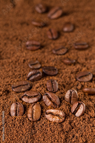 Coffee Beans macro on ground coffee background.