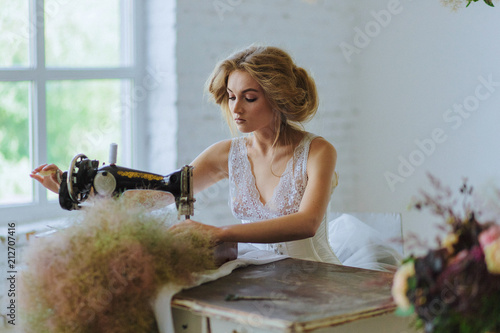 Pretty Woman. In the style of Coco Chanel sitting on a sewing machine photo