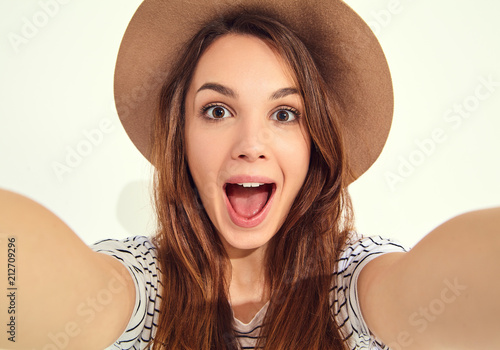 pretty girl in summer hipster clothes take selfie from hands with phone