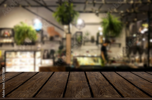 Selected focus empty brown wooden table and Coffee shop or restaurant blur background with bokeh image. for your photomontage or product display