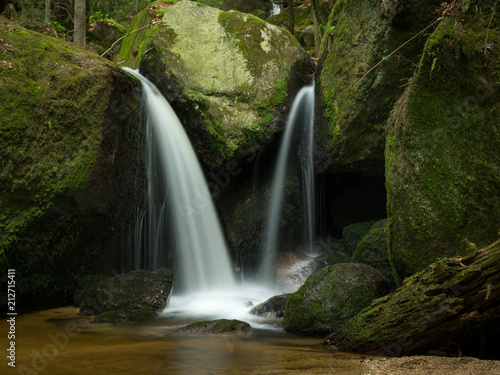 Waterfall, cascade between big rocks in ravine Ysperklamm