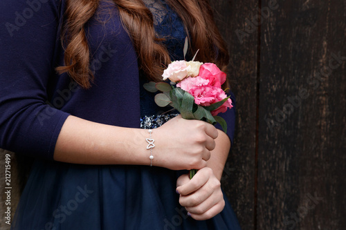 close up hands holding a bouquet of the valley confirmation tradition