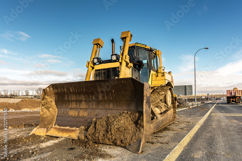 Excavator performing repairs of a road