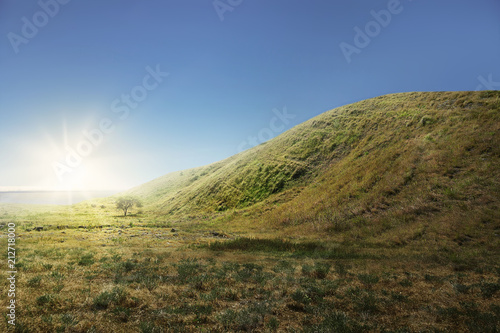 Green hill with grass field