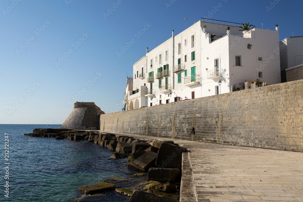 Seafront promede with fortification wall remains in Monopoli, Adriatic Sea, Apulia, Bari province, Italy, Europe