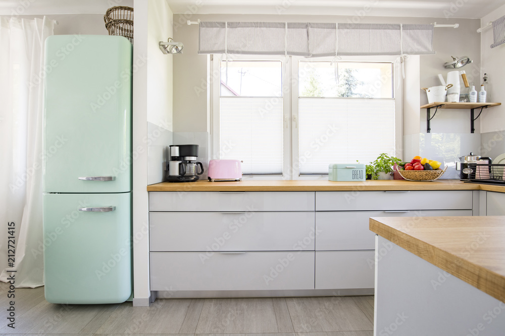 Neo mint fridge standing in real photo of bright kitchen interio Neo mint fridge standing in real photo of bright kitchen interio
