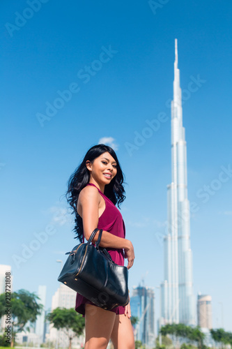 Tourist woman on city vacation in Dubai front of burj al khalifa