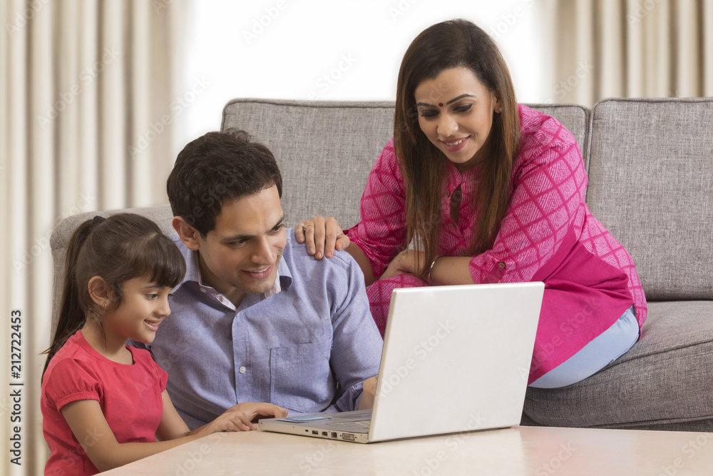 Family using credit card for shopping online Family using credit card for shopping online