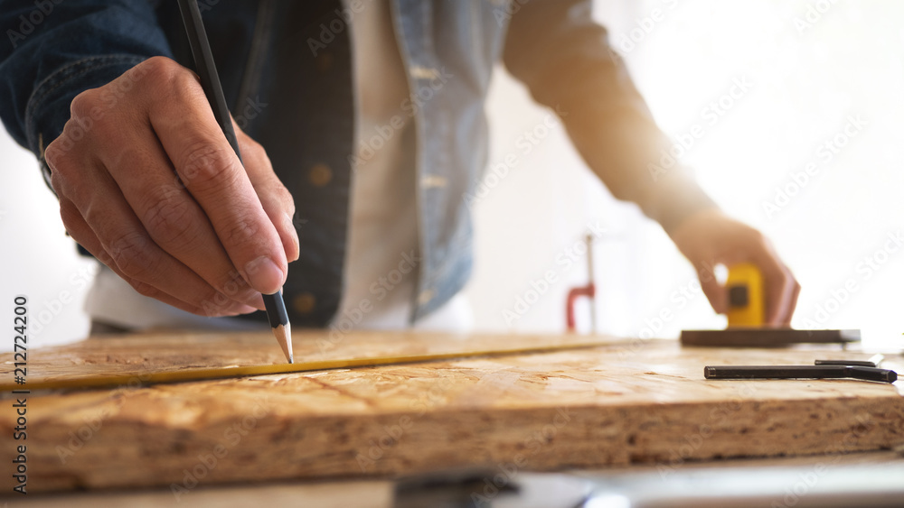 carpenter working on wooden board