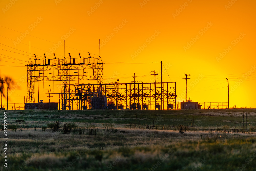 A Small Energy Plant Silhouette at Sunrise on the Plains of Colorado