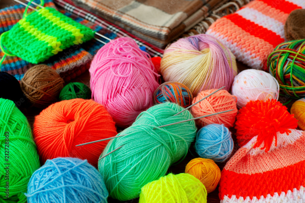 Many colorful balls of yarn for knitting. Multicolored yarn for
