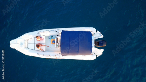 Aerial top view photo of docked inflatible in tropical clear waters photo