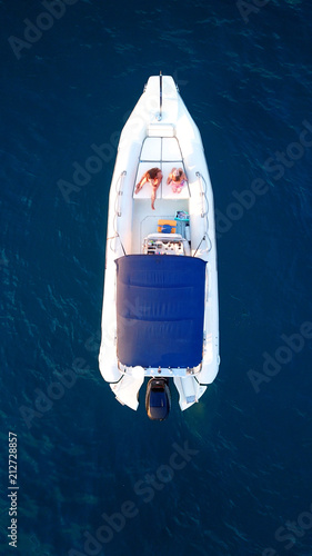 Aerial top view photo of docked inflatible in tropical clear waters © aerial-drone