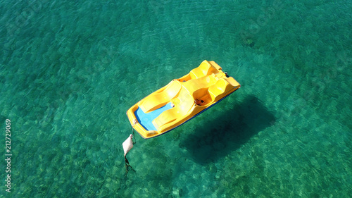 Aerial photo of yellow sea bike parked at tropical beach 