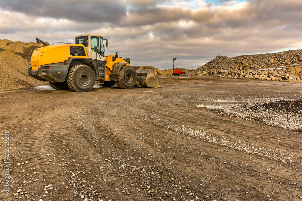 Excavator moving stone in an open pit mine in Spain Excavator moving stone in an open pit mine in Spain