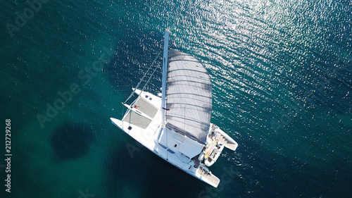 Fotografie, Tablou Aerial drone bird's eye view photo from luxury Catamaran docked at tropical deep