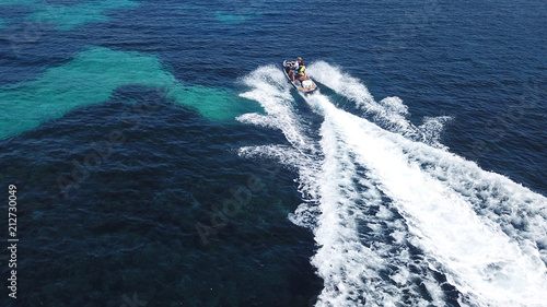 Top view of jet ski cruising in deep blue sea © aerial-drone
